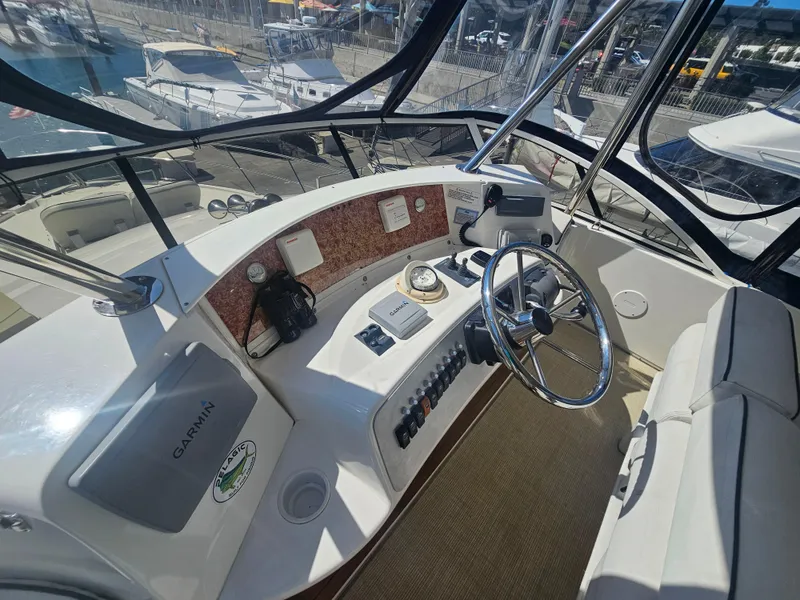 Slide: The Image of Helm of 2012 Silverton West Coast Edition yacht with steering wheel and navigation equipment. - 24