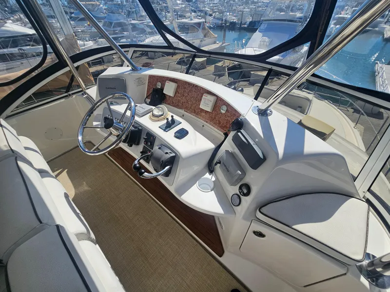 Slide: The Image of 2012 Silverton West Coast Edition yacht helm with steering wheel and navigation equipment. - 26