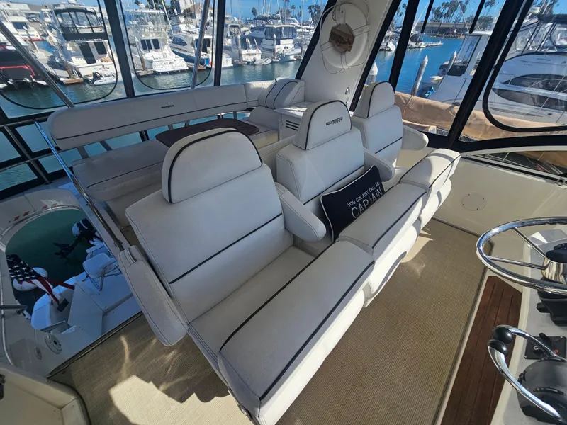 Slide: The Image of Interior of 2012 Silverton West Coast Edition yacht with white seating and marina view. - 27