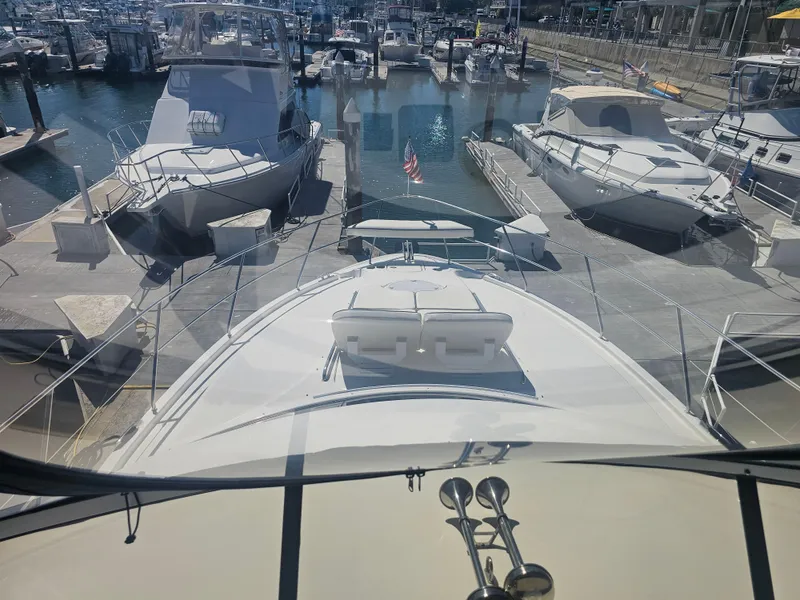 Slide: The Image of 2012 Silverton West Coast Edition yacht docked at a marina, surrounded by other boats. - 29