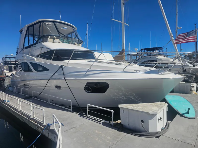 Slide: The Image of 2012 Silverton West Coast Edition yacht docked at marina under clear blue sky. - 3