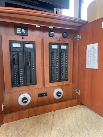 Slide: The Image of Electrical panel inside 2012 Silverton West Coast Edition yacht, featuring circuit breakers and controls. - 35