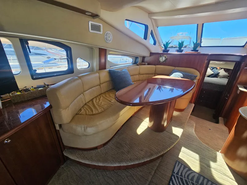 Slide: The Image of Luxurious 2012 Silverton West Coast Edition yacht interior with plush seating and elegant wood finishes. - 36