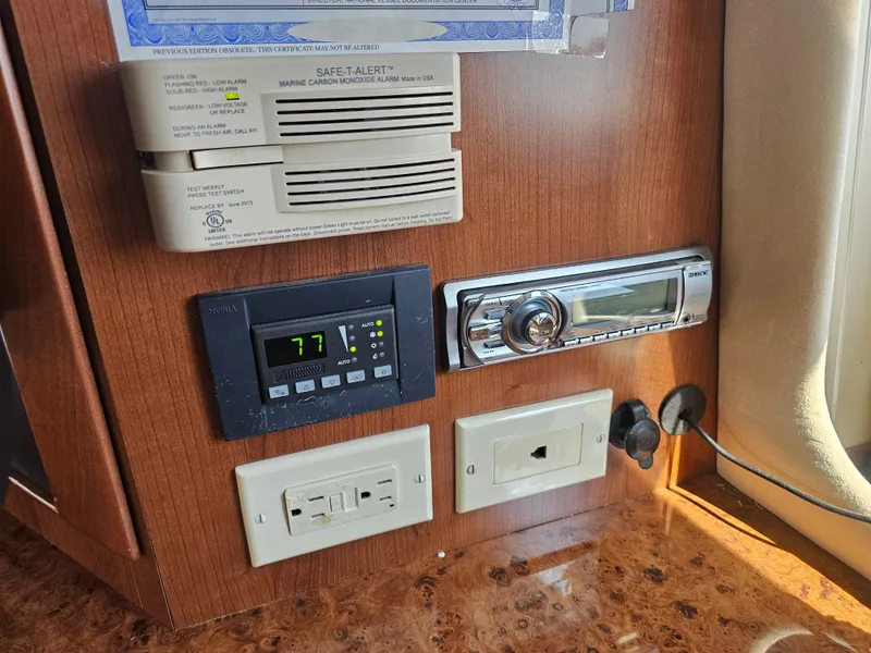 Slide: The Image of Control panel in 2012 Silverton West Coast Edition boat with thermostat and stereo system. - 37