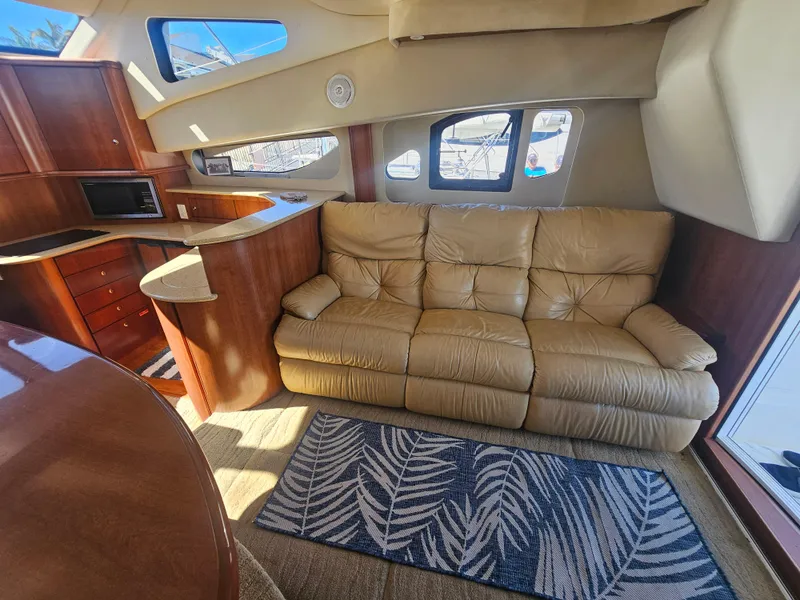 Slide: The Image of Luxurious interior of 2012 Silverton West Coast Edition yacht with leather sofa and wooden cabinetry. - 38