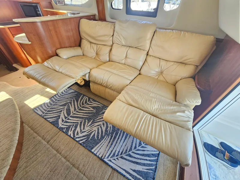 Slide: The Image of Luxurious beige recliner sofa in 2012 Silverton West Coast Edition yacht interior. - 39