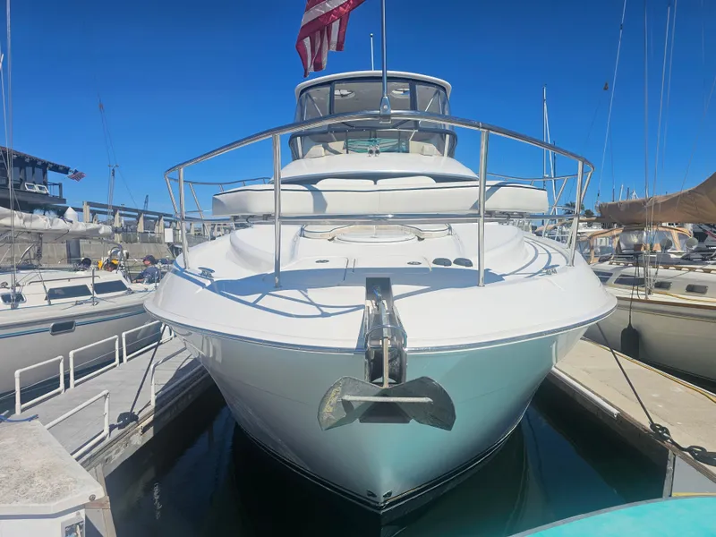 Slide: The Image of 2012 Silverton West Coast Edition yacht docked at marina, front view with clear blue sky. - 4