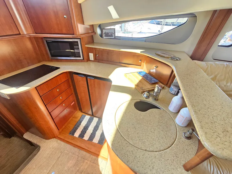 Slide: The Image of Luxurious 2012 Silverton West Coast Edition yacht kitchen with modern amenities and wood cabinetry. - 42