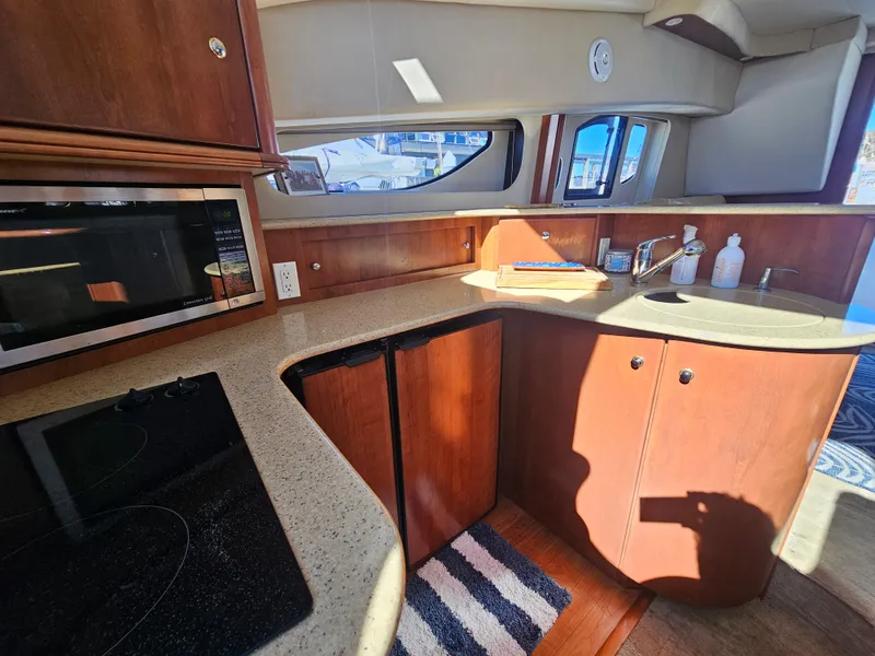 Slide: The Image of 2012 Silverton West Coast Edition yacht kitchen with microwave, stove, and sink. - 44