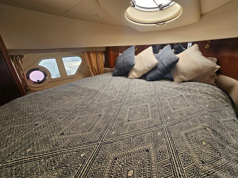 Slide: The Image of Luxurious cabin interior of 2012 Silverton West Coast Edition yacht with patterned bedding. - 47