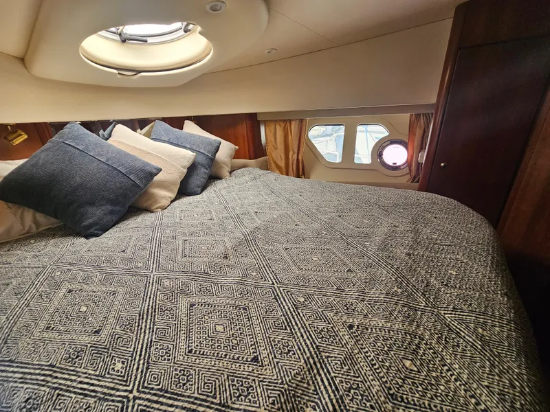 Slide: The Image of Luxurious cabin interior of 2012 Silverton West Coast Edition yacht with patterned bedding. - 48