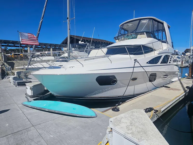 Slide: The Image of 2012 Silverton West Coast Edition yacht docked at marina with American flag. - 5