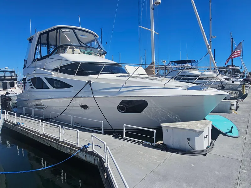 Slide: The Image of 2012 Silverton West Coast Edition yacht docked at marina under clear blue sky. - 6