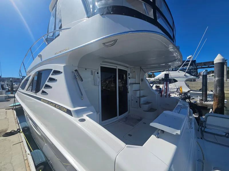 Slide: The Image of 2012 Silverton West Coast Edition yacht docked at marina under clear blue sky. - 9