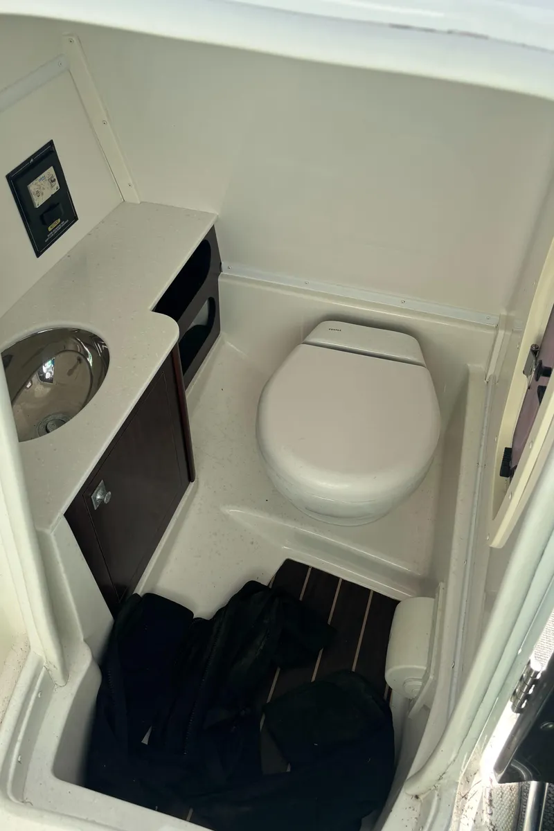 Slide: The Image of Compact bathroom in 2017 Monterey M65 boat with toilet, sink, and storage. - 12