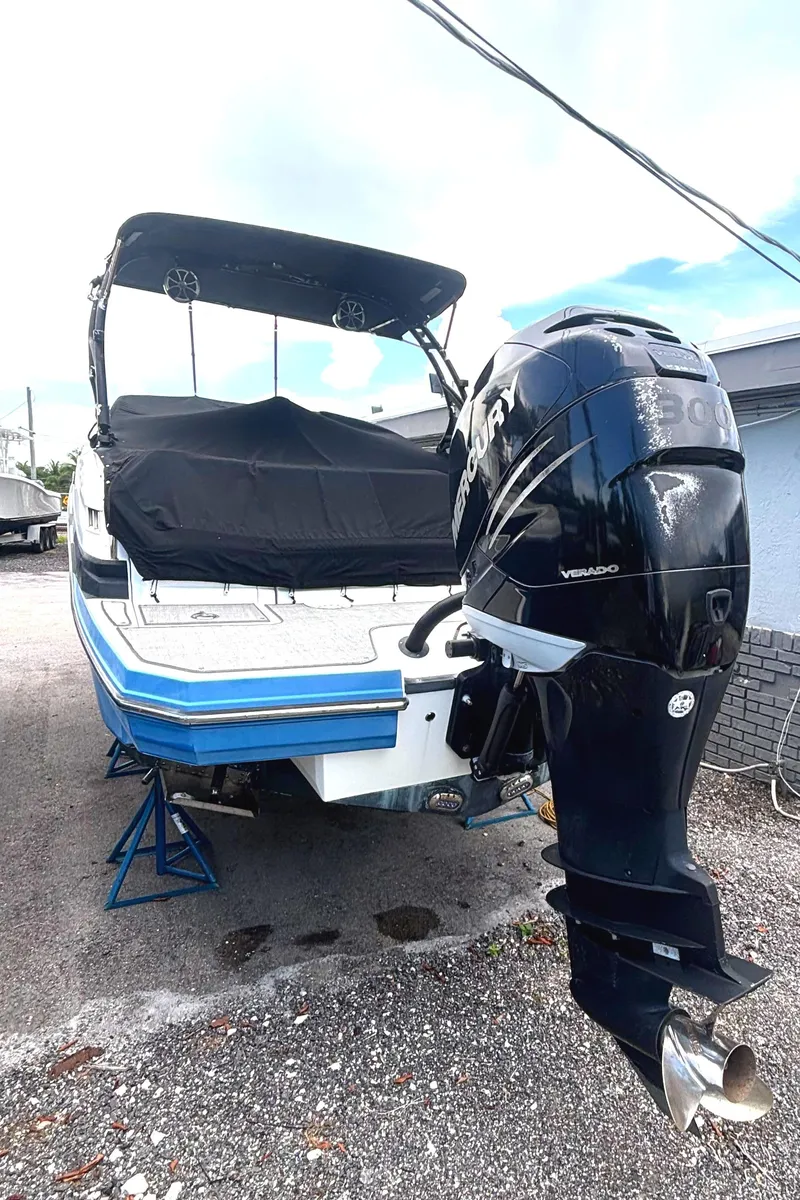 Slide: The Image of 2017 Monterey M65 boat with Mercury Verado engine on stands, covered and parked outdoors. - 2