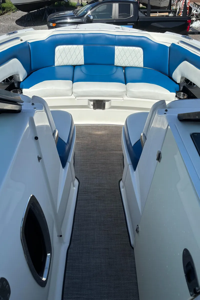 Slide: The Image of 2017 Monterey M65 boat interior with blue and white seating, viewed from the deck. - 3