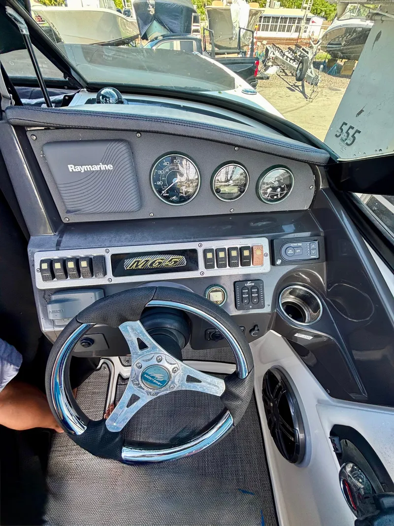 Slide: The Image of Dashboard of a 2017 Monterey M65 boat with steering wheel and gauges. - 5