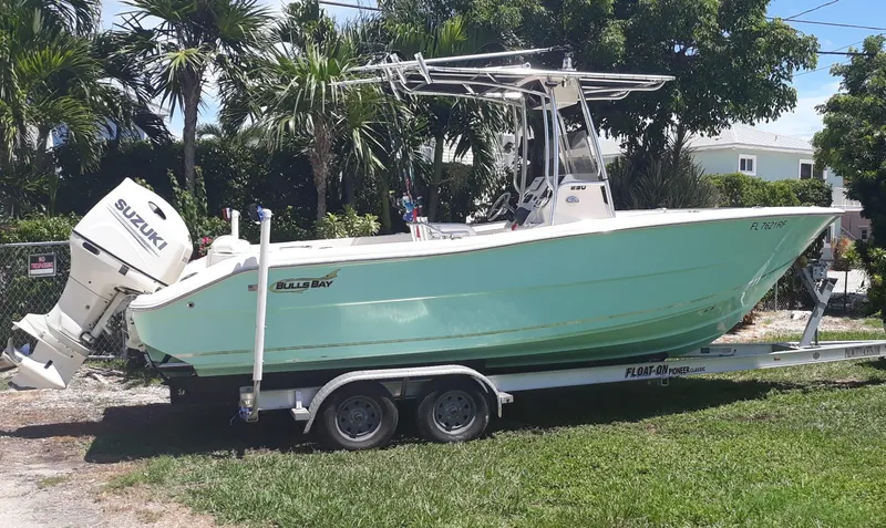 The Image of 2017 Bulls Bay 230 Center Console boat on trailer, parked beside RV. - 0
