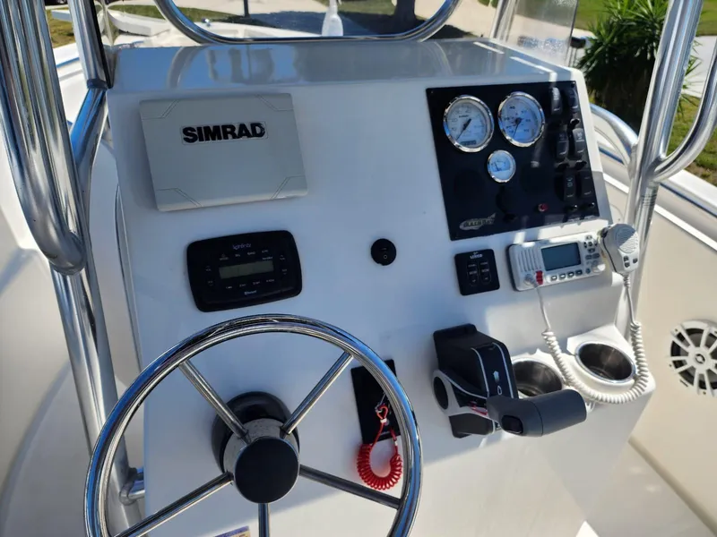 Slide: The Image of 2017 Bulls Bay 230 Center Console boat interior with steering wheel and seating. - 19