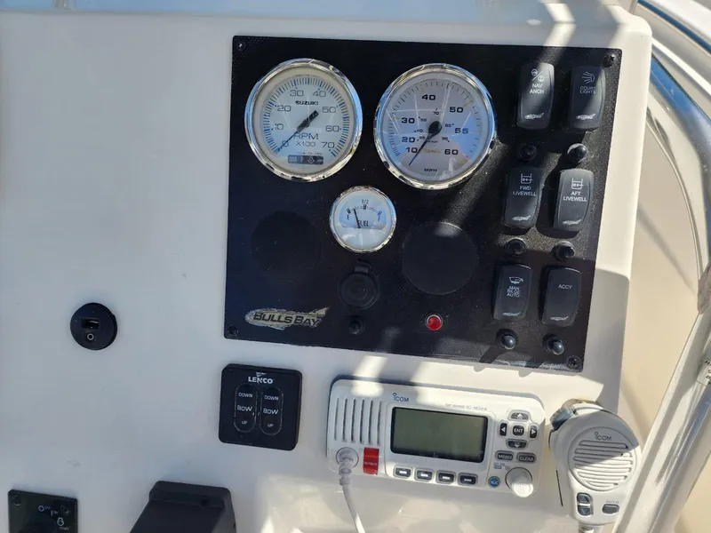 Slide: The Image of 2017 Bulls Bay 230 Center Console boat dashboard with controls and radio equipment. - 20