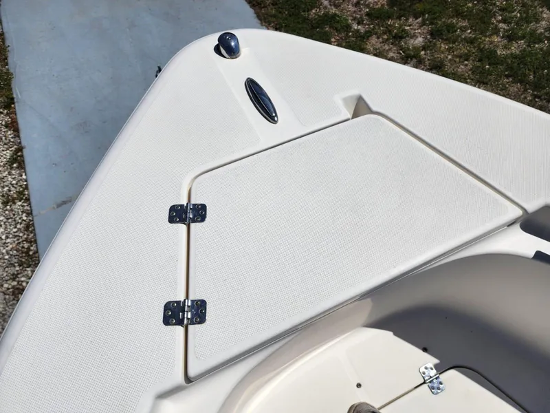 Slide: The Image of Open storage compartment on a 2017 Bulls Bay 230 Center Console boat. - 27