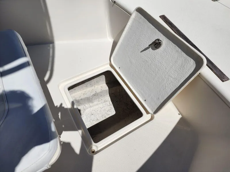 Slide: The Image of 2017 Bulls Bay 230 Center Console boat deck with storage compartment and hinges. - 29