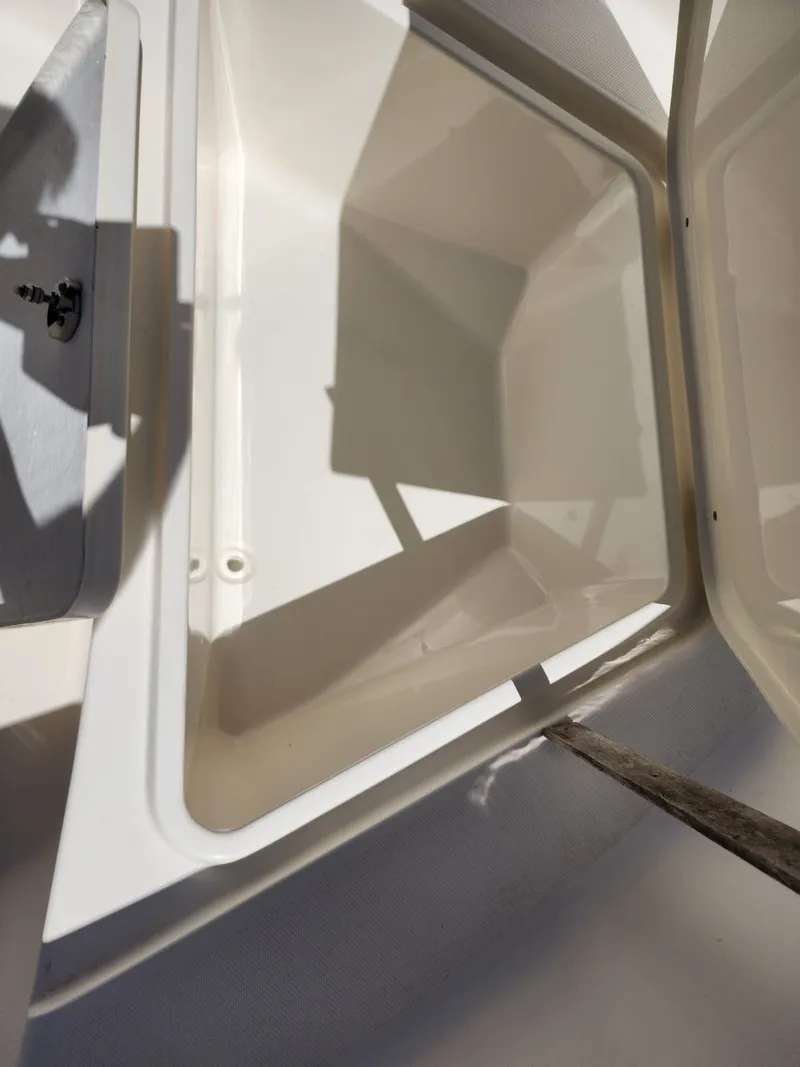 Slide: The Image of 2017 Bulls Bay 230 Center Console boat seat with logo, white upholstery, and stainless steel frame. - 30