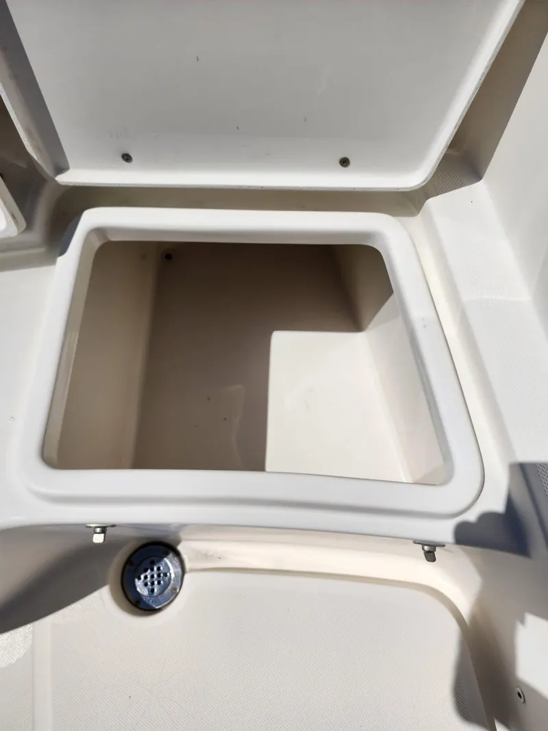 Slide: The Image of Open storage compartment on a 2017 Bulls Bay 230 Center Console boat. - 32