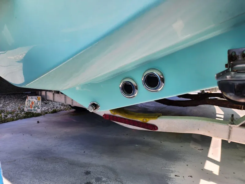 Slide: The Image of 2017 Bulls Bay 230 Center Console boat with T-top, surrounded by lush greenery and palm trees. - 39