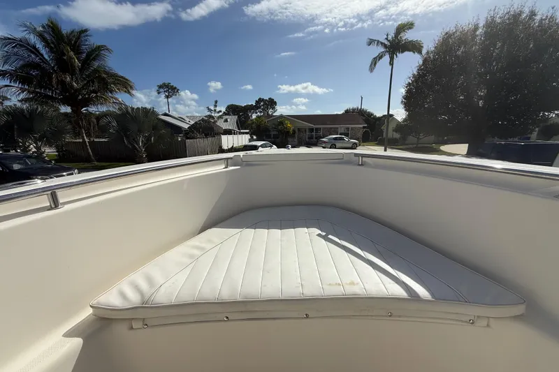 Slide: The Image of 2017 Bulls Bay 230 Center Console boat on trailer, covered, beside a white truck and blue house. - 47
