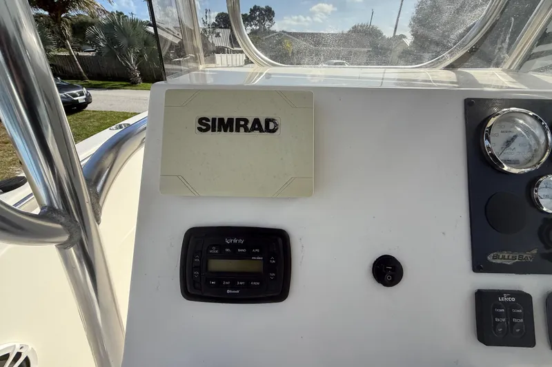 Slide: The Image of 2017 Bulls Bay 230 Center Console boat dashboard with steering wheel and navigation instruments. - 50