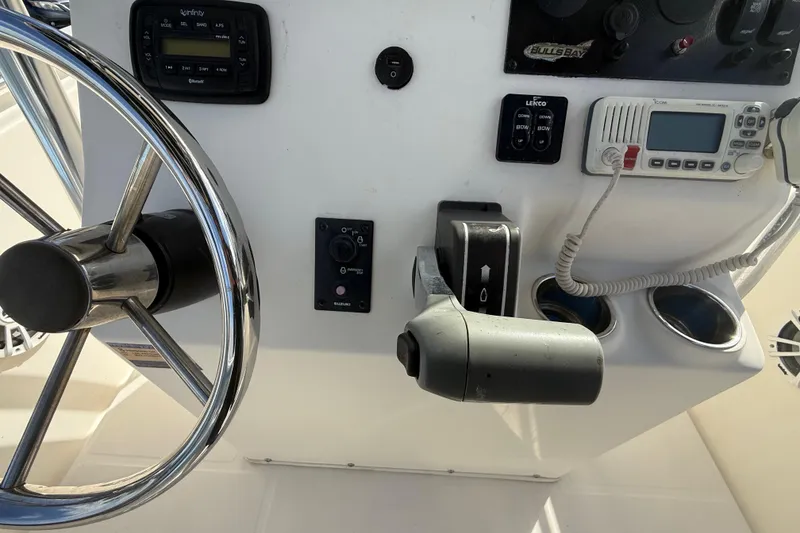 Slide: The Image of 2017 Bulls Bay 230 Center Console dashboard with Simrad and Infinity controls. - 51