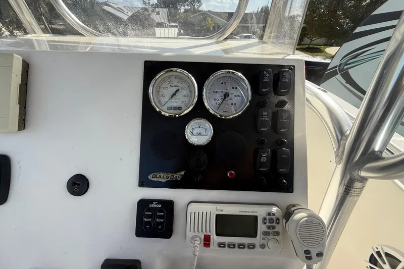 Slide: The Image of 2017 Bulls Bay 230 Center Console boat dashboard with steering wheel and controls. - 52