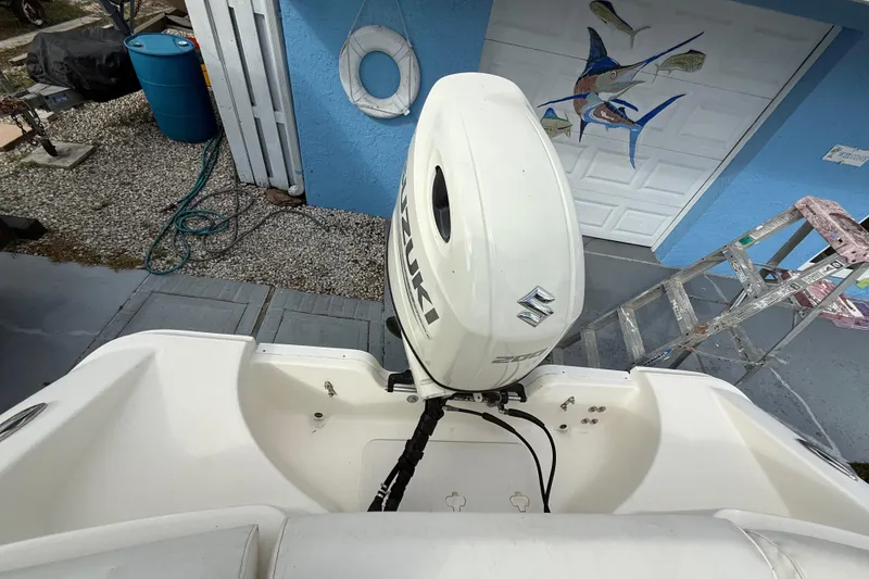 Slide: The Image of 2017 Bulls Bay 230 Center Console boat with T-top and rod holders. - 58