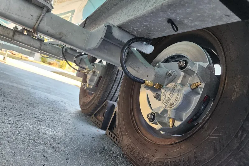 Slide: The Image of Trailer wheel and axle of a 2017 Bulls Bay 230 Center Console boat. - 64