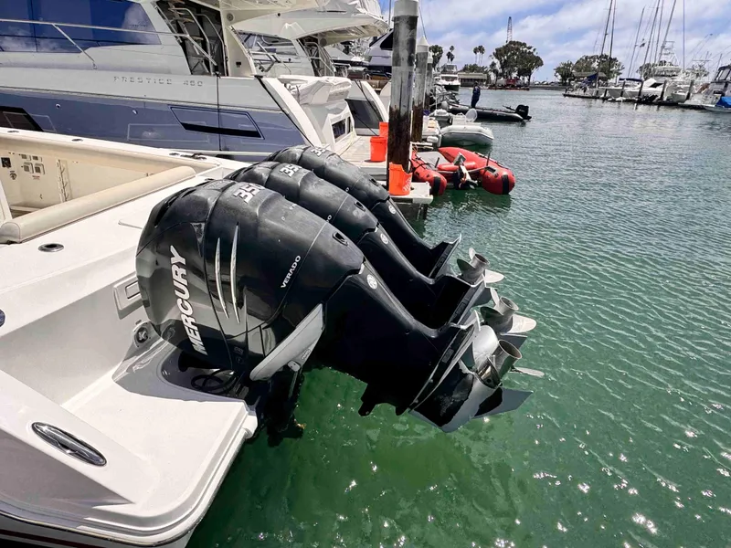 Slide: The Image of 2018 Boston Whaler 350 Outrage with triple Mercury outboard engines docked at marina. - 11