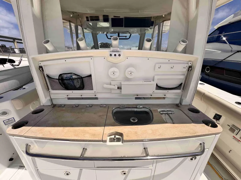 Slide: The Image of 2018 Boston Whaler 350 Outrage boat interior with fishing station and sink. - 12