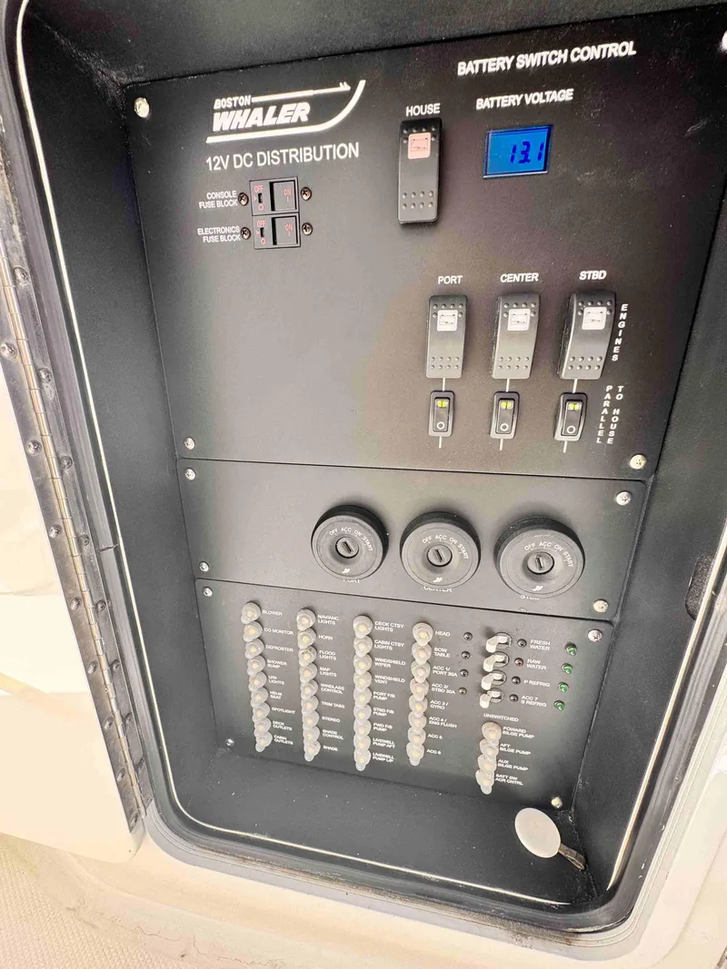 Slide: The Image of Control panel of a 2018 Boston Whaler 350 Outrage boat, showing battery switch and distribution. - 14