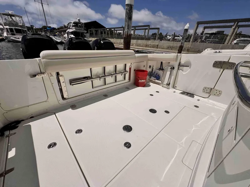 Slide: The Image of 2018 Boston Whaler 350 Outrage boat deck with fishing rod holders and storage. - 16