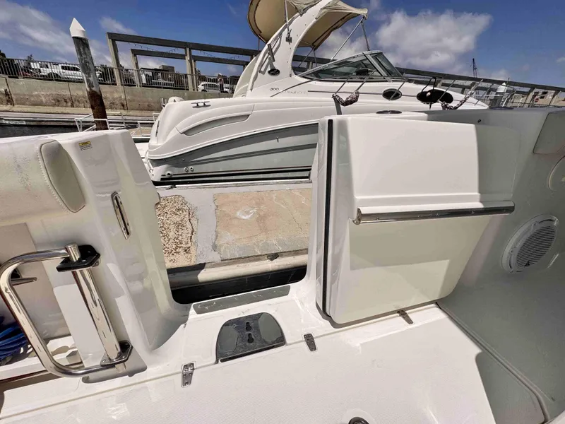 Slide: The Image of 2018 Boston Whaler 350 Outrage docked, featuring open side door and sleek design. - 20