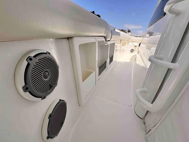Slide: The Image of 2018 Boston Whaler 350 Outrage interior with speakers and storage compartments. - 22
