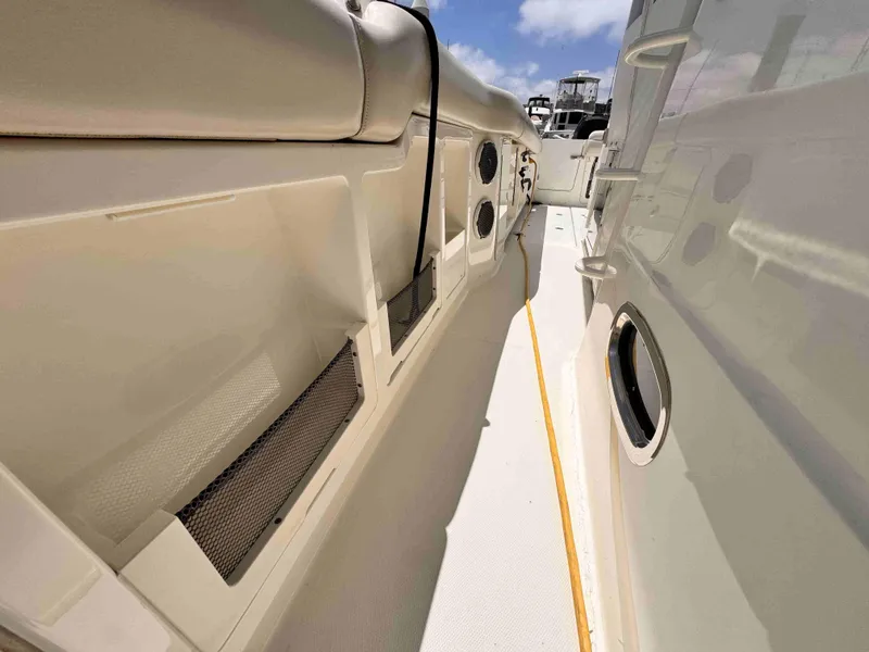 Slide: The Image of 2018 Boston Whaler 350 Outrage boat deck with seating and storage compartments. - 26