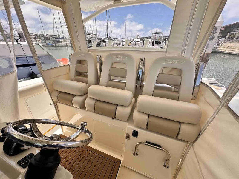 Slide: The Image of Interior of 2018 Boston Whaler 350 Outrage with plush seating and steering wheel. - 28