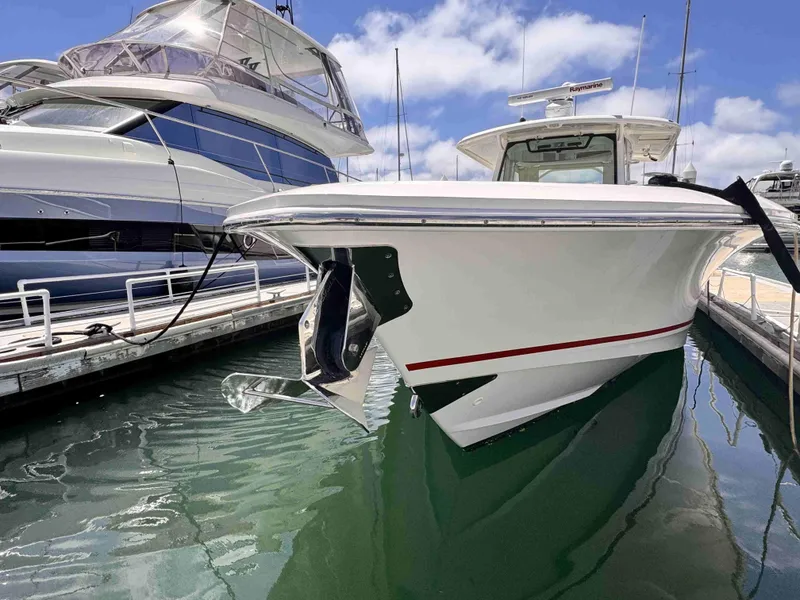 Slide: The Image of 2018 Boston Whaler 350 Outrage docked, showcasing sleek design and modern features. - 3