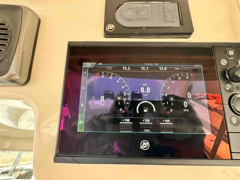 Slide: The Image of Dashboard of a 2018 Boston Whaler 350 Outrage boat showing digital gauges and controls. - 32