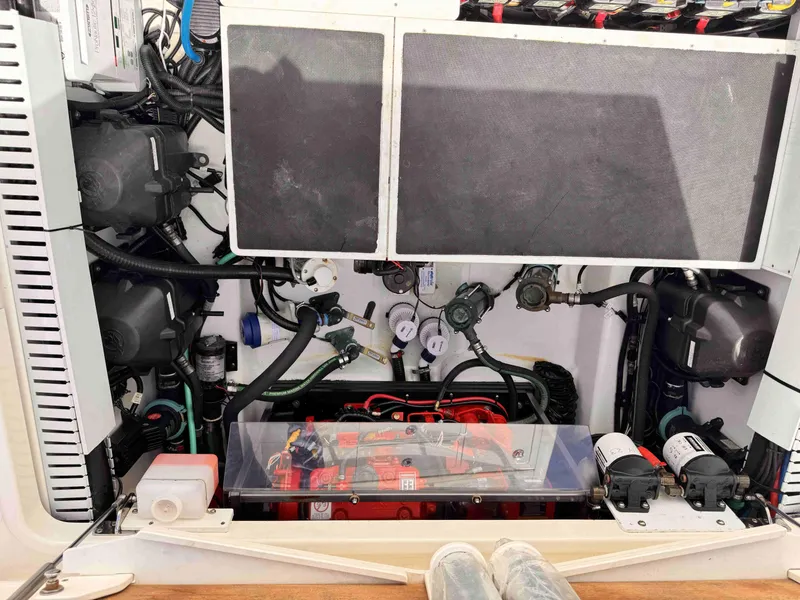 Slide: The Image of Engine compartment of a 2018 Boston Whaler 350 Outrage, showcasing mechanical components and wiring. - 38