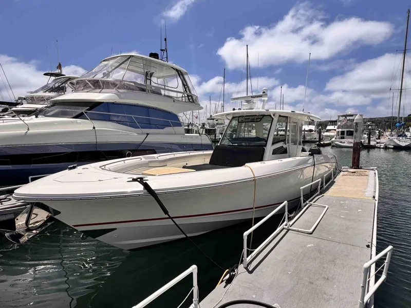 Slide: The Image of 2018 Boston Whaler 350 Outrage docked at marina under blue sky. - 4