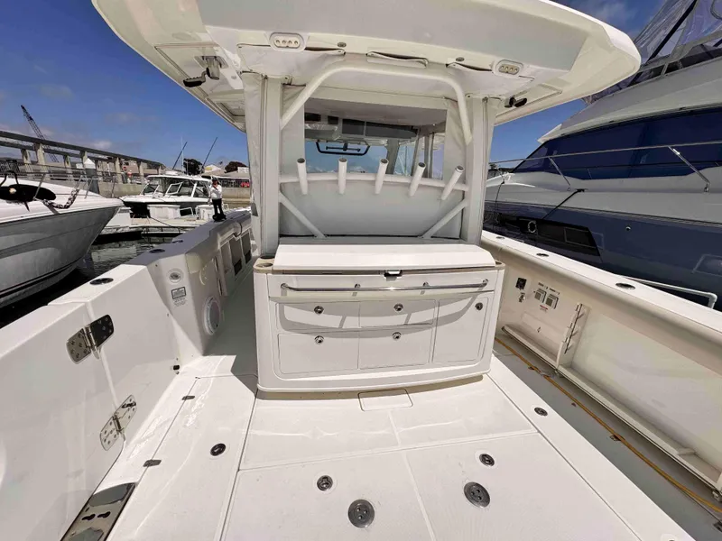 Slide: The Image of 2018 Boston Whaler 350 Outrage boat interior with storage and seating, docked at marina. - 40