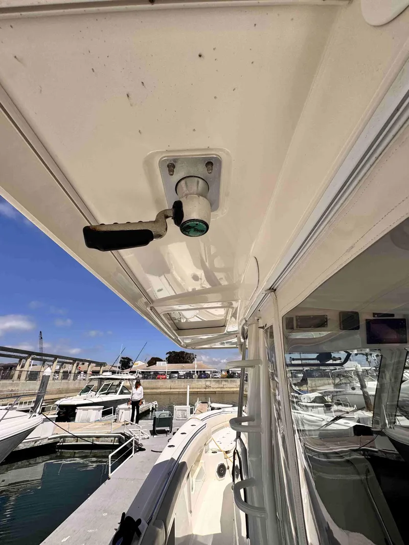 Slide: The Image of 2018 Boston Whaler 350 Outrage docked, showcasing deck and cabin details. - 41